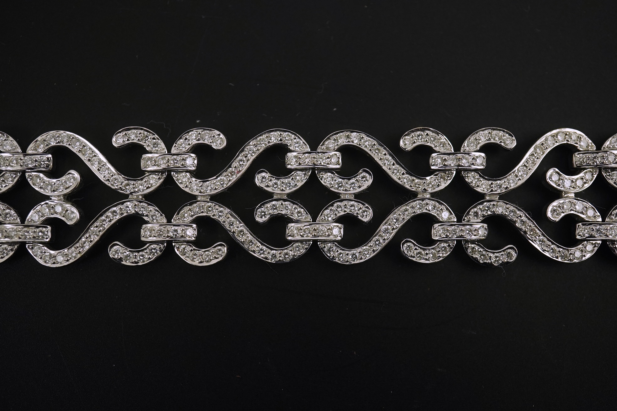 A modern 18k white gold and diamond chip cluster set bracelet